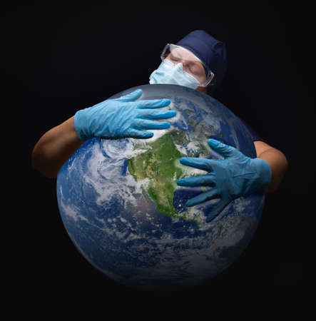 Nurse or Doctor Wearing Face Mask and Surgical Gloves Hugging the Planet Earth.の写真素材