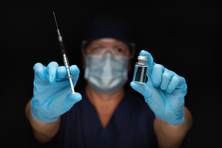 Doctor or Nurse Holding Medical Syringe and Vial.の写真素材
