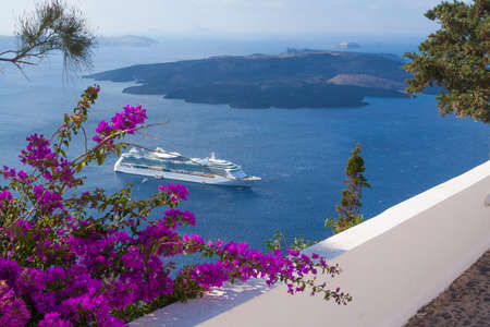 Bougainvillea adorn walkway as passenger cruise ship anchors off the coast of Greece..の写真素材