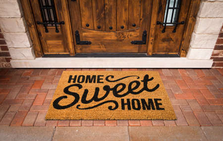 Home Sweet Home Welcome Mat At Custom Front Door of House.の写真素材