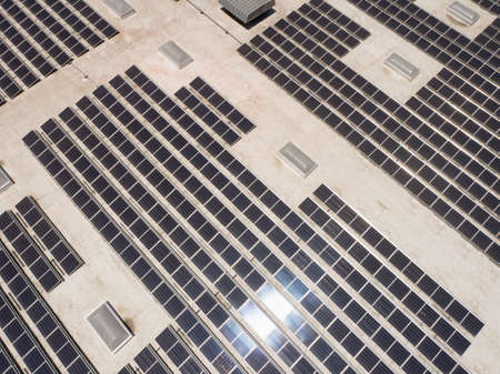 Aerial View of Solar Panels Mounted on Roof of Large Industrial Building or Warehouse.の写真素材