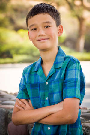 Outdoor portrait of a mixed race Chinese and Caucasian boy.の写真素材
