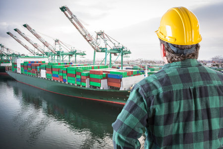 Male Worker Wearing Yellow Hard Hat Overlooking the San Pedro Ship Yard.の写真素材
