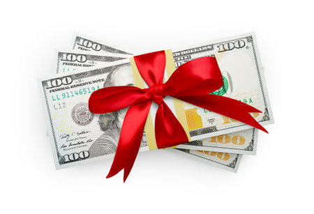 Thirty Thousand Dollars Stack of One Hundred Dollar Bills Wrapped in a Red Bow Isolated on a White Background.の写真素材