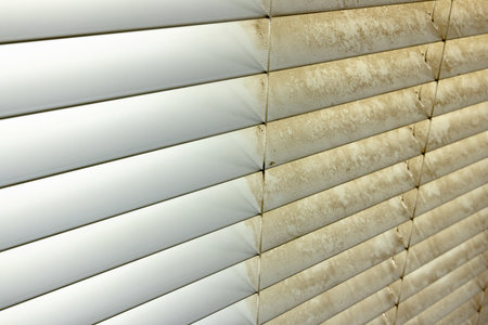 Residential Window Shades Showing the Before and After of a Good Cleaning - One Side Clean and One Side Dirty.の写真素材