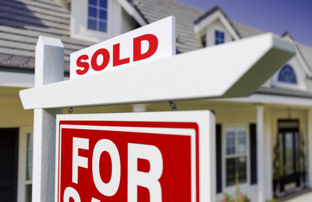 Sold For Sale Real Estate Sign In Front of New House.の写真素材