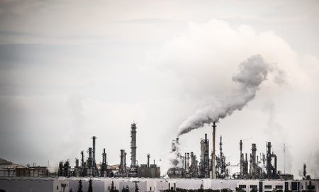 Working Industrial Plant with Smoke Stacks Billowing Smoke Into The Air.の写真素材