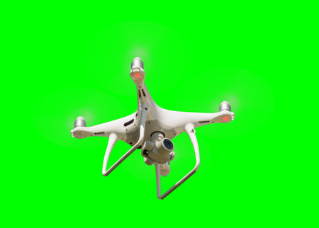 Isolated Unmanned Aircraft System (UAV) Quadcopter Drone In The Air Over A Green Screen.の写真素材