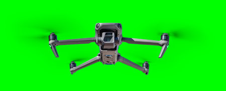 Isolated Unmanned Aircraft System (UAV) Quadcopter Drone In The Air Over A Green Screen.の写真素材