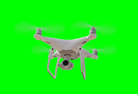 Isolated Unmanned Aircraft System (UAV) Quadcopter Drone In The Air Over A Green Screen.の写真素材