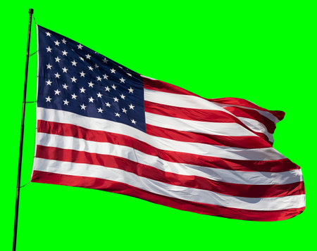 American Flag Waving In The Wind on a Flag Pole Over a Green Screen.の写真素材