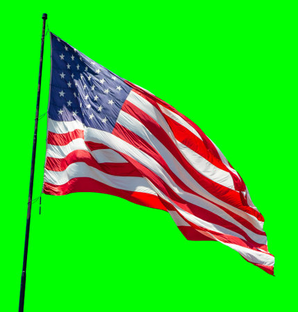 American Flag Waving In The Wind on a Flag Pole Over a Green Screen.の写真素材