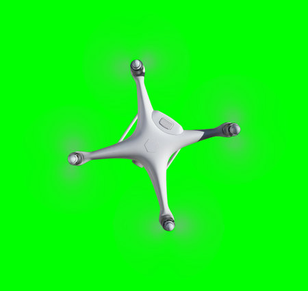 Isolated Top View of an Unmanned Aircraft System (UAV) Quadcopter Drone In The Air Over A Green Screen.の写真素材