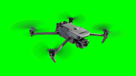 Isolated Unmanned Aircraft System (UAV) Quadcopter Drone In The Air Over A Green Screen.の写真素材