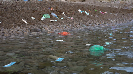 medical plastic waste. Used disposable masks and gloves thrown out by the waves. Garbage on the sea...