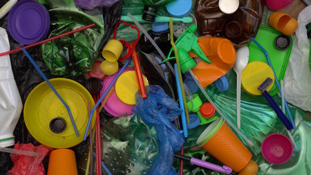 A pile of plastic garbage, food and beverage packaging. Sorting of waste. Recycling, pollution,...