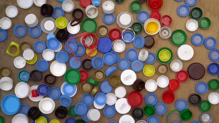 Used plastic drink bottle caps and lids. Polypropylene 5, polyethylene . Waste sorting and recycle