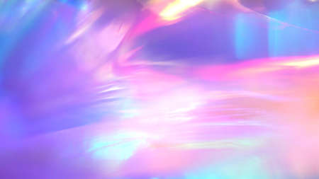 A holographic rainbow unicorn pastel purple pink teal colors abstract background. Optical crystal prism flare beams. Light flares. Christmas textureの写真素材