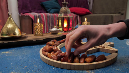 Fasting during Ramadan. Organic dates palm fruit serving during Iftar and sahoor meal on dining...