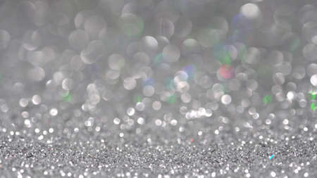 Silver holographic glitter shine background, highlights and bokehの写真素材