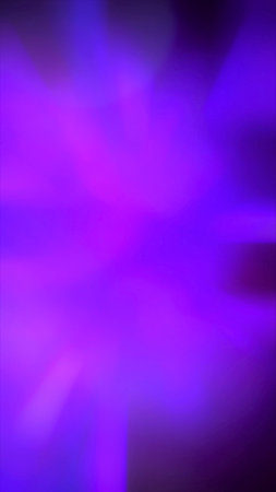 Defocused neon glow. Light flare overlay. Futuristic led illumination. Blur ultraviolet magenta pink purple blue color radiance on dark abstract backgroundの写真素材