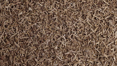 Shredded cardboard material for gift baskets, mulch, compost, worm bin. Cardboard shreds background.