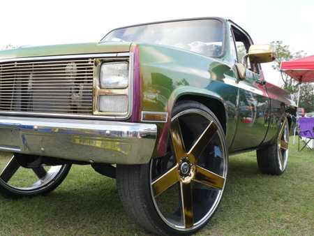 Vintage truck with gold wheels and luxury paint job.