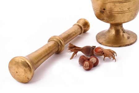 The Hazelnut and in the leaf old metal nutcracker on white backgroundの写真素材