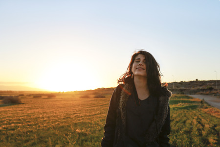 Happy woman with sunset in Cyprus.の写真素材