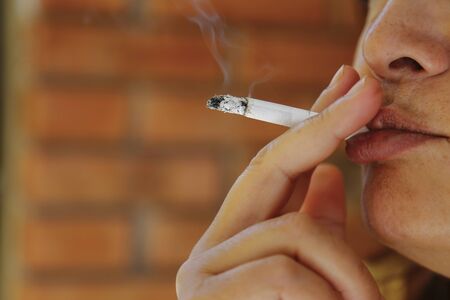 Smoking woman - unhealthy activity for human.の写真素材