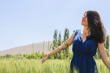 There is nice image for nature. Happy woman in the young green wheat.の写真素材