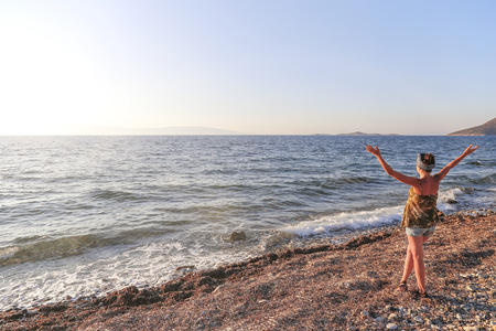 Woman with sunburn at he sunset in the beach.の写真素材