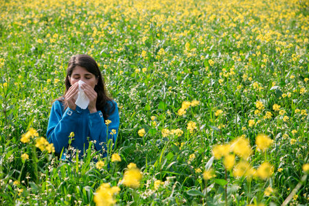 The woman polen allergy with yellow flowers.