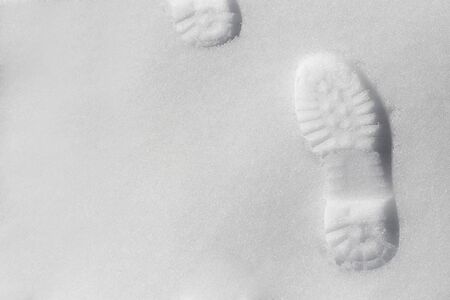The footprint in snow and natural sunlight.の写真素材