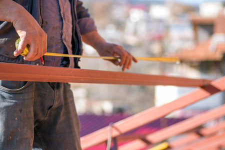 Repairman at the iron work on the roof.