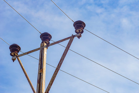 Electrical pole and line with sky.