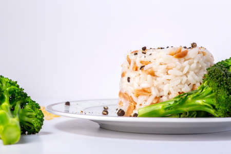Rice with barley noodles and fresh broccoli on the plate.の写真素材
