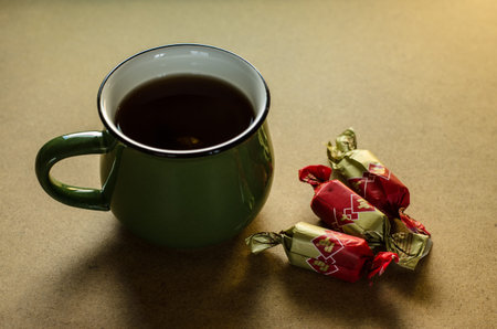 Black tea in green cup on tableの写真素材