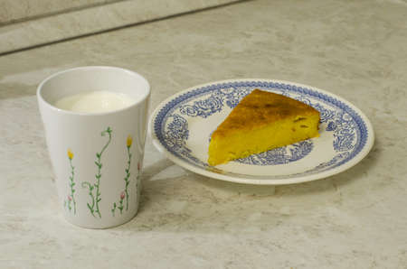 piece of hot pumpkin pie with cup of milkの写真素材