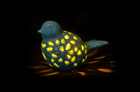 Night bird lamp in dark backgroundの写真素材