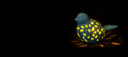 Night bird lamp in dark backgroundの写真素材