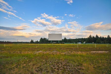 Abandened drive in screen with sky and grassの写真素材