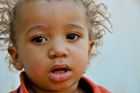 Baby boy's face with a blank look. Soft focus.の写真素材