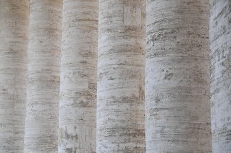 Row of white and tan marble columns in a row.の写真素材