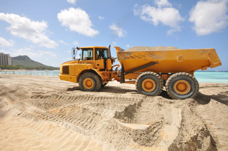 Sandy beach with a dump trunk full of sand