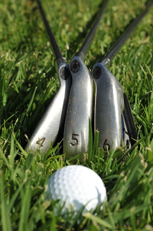 A four, five and six iron with a golf ball in grassの写真素材