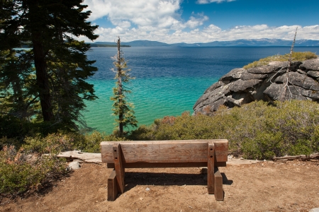 Old wooden bench looks over Lake Tahoeの写真素材