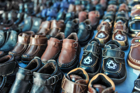 A swap meet table full of kids shoes for saleの写真素材