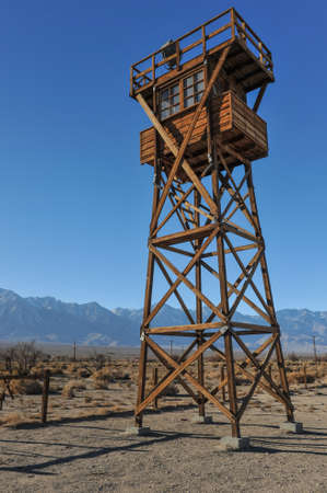 Guard tower with a search light in the desert by the mountainsの写真素材