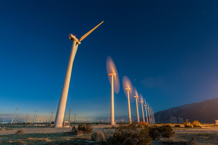 Many wind turbines in the desert during sunrise.の写真素材